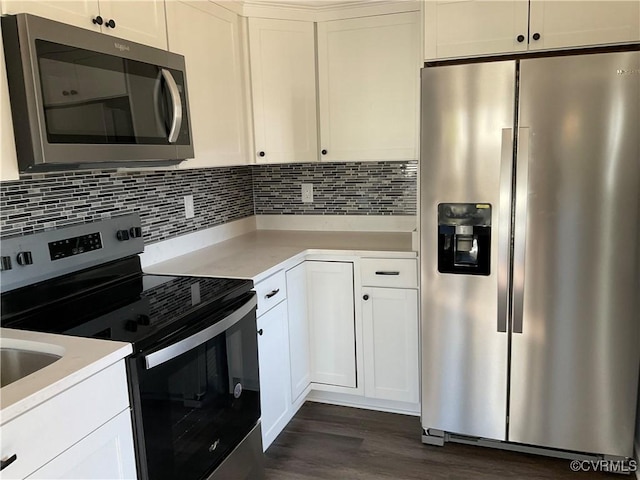 kitchen with white cabinets, dark hardwood / wood-style flooring, appliances with stainless steel finishes, and tasteful backsplash