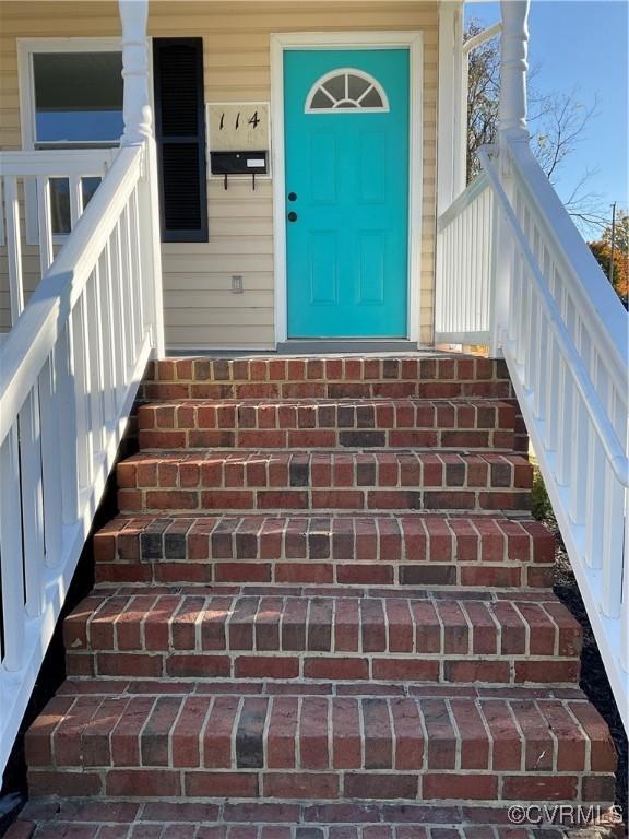 view of exterior entry featuring a porch