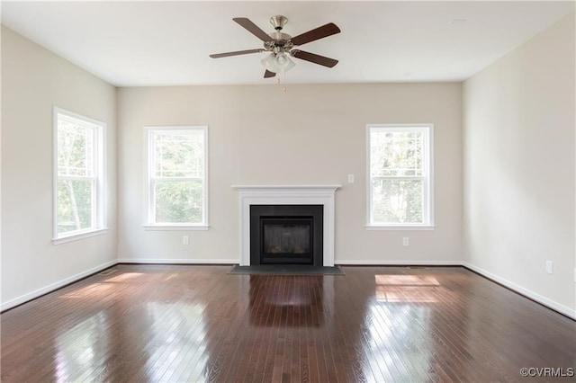 unfurnished living room with dark hardwood / wood-style floors and ceiling fan