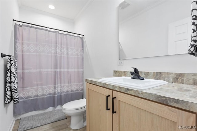 bathroom with vanity, crown molding, hardwood / wood-style flooring, toilet, and curtained shower