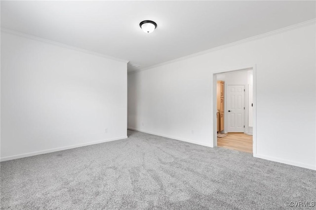 carpeted spare room with crown molding