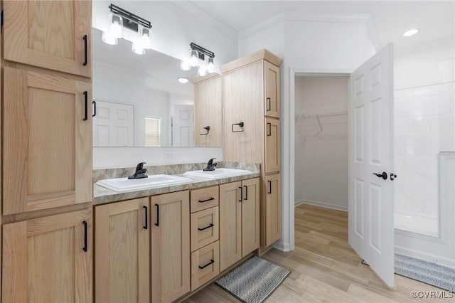 bathroom with vanity, wood-type flooring, and ornamental molding