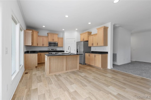 kitchen with a kitchen island with sink, crown molding, stainless steel appliances, and light brown cabinets