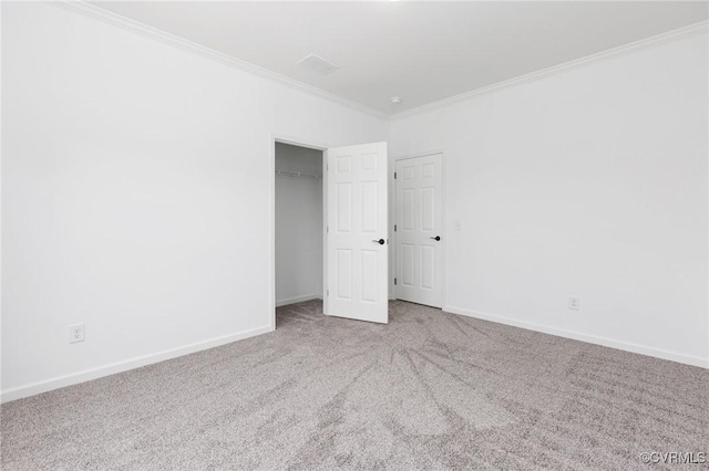 carpeted spare room featuring ornamental molding