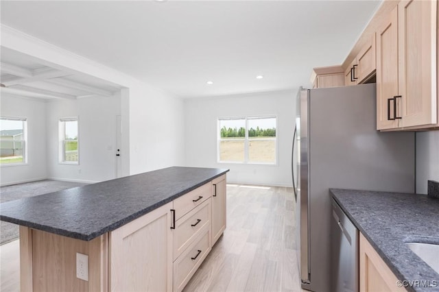 kitchen featuring beamed ceiling, light brown cabinets, and coffered ceiling