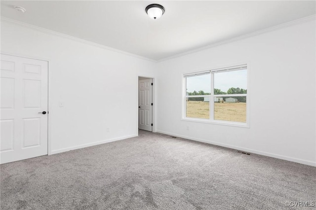 carpeted empty room featuring crown molding