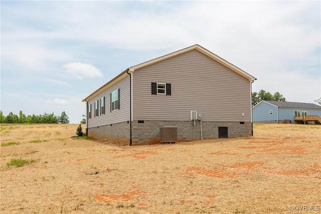 view of side of property featuring central AC