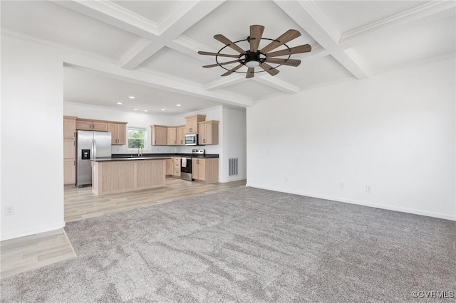 unfurnished living room featuring ceiling fan, beam ceiling, and coffered ceiling