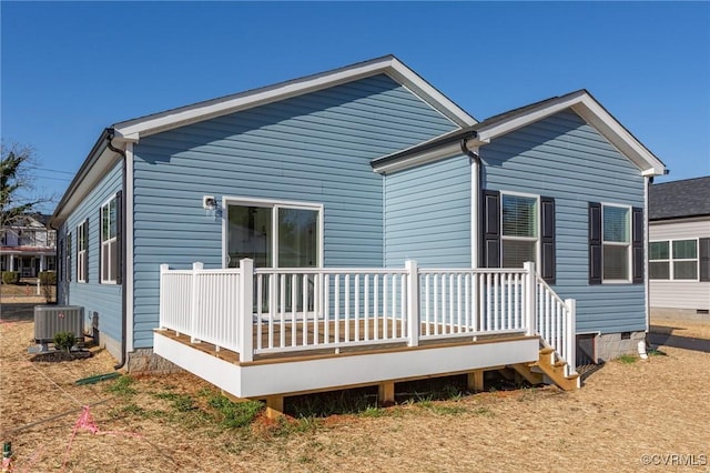 rear view of property featuring cooling unit and a deck