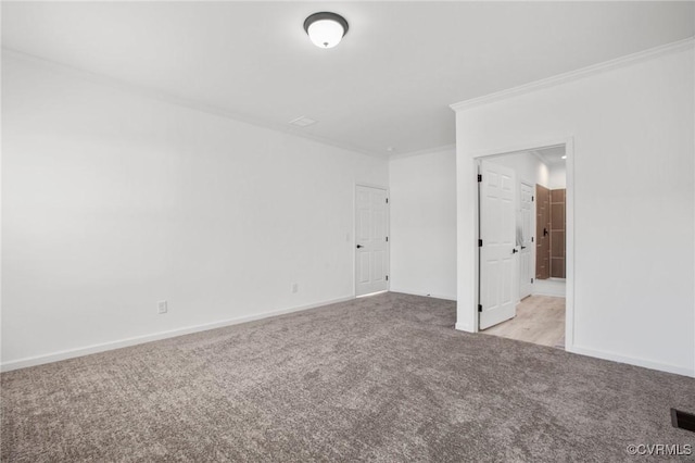 unfurnished room with ornamental molding and light carpet