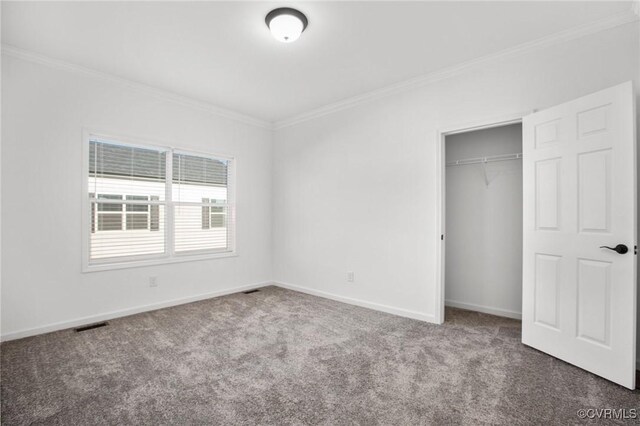 unfurnished bedroom with a closet, carpet floors, and ornamental molding