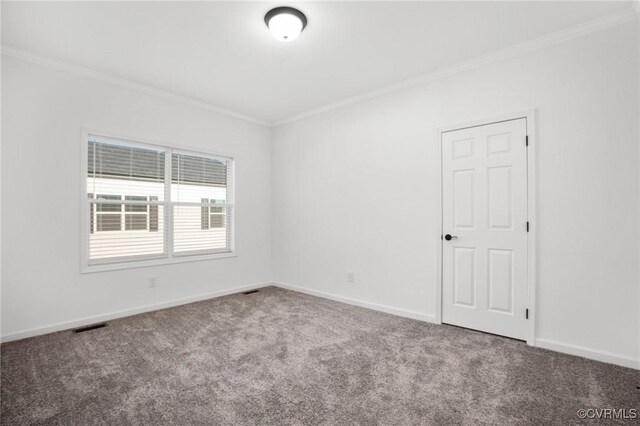 unfurnished room featuring carpet flooring and crown molding