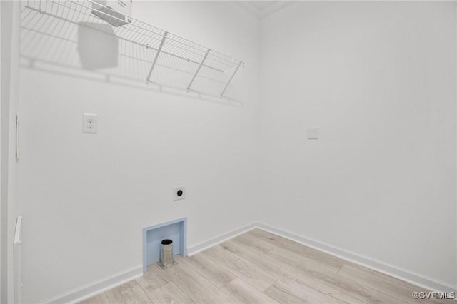 clothes washing area featuring light hardwood / wood-style flooring, ornamental molding, and hookup for an electric dryer