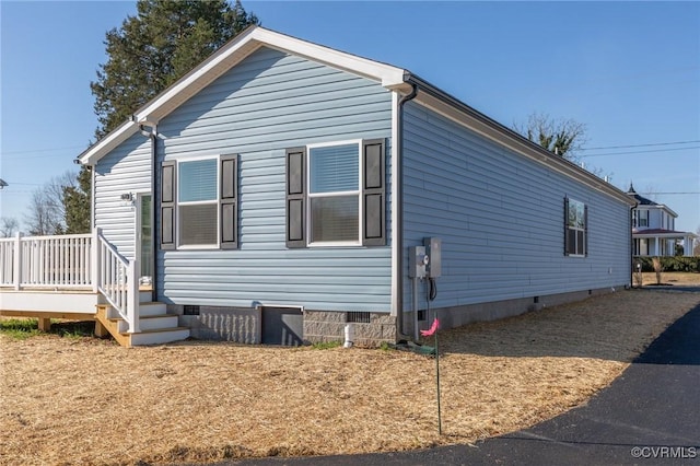 view of home's exterior featuring a wooden deck