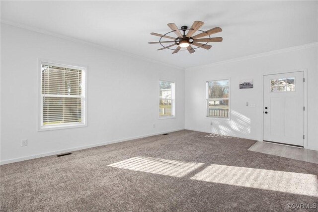 interior space featuring carpet flooring, ceiling fan, and ornamental molding