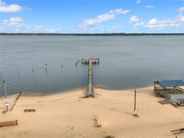 property view of water featuring a boat dock and a view of the beach