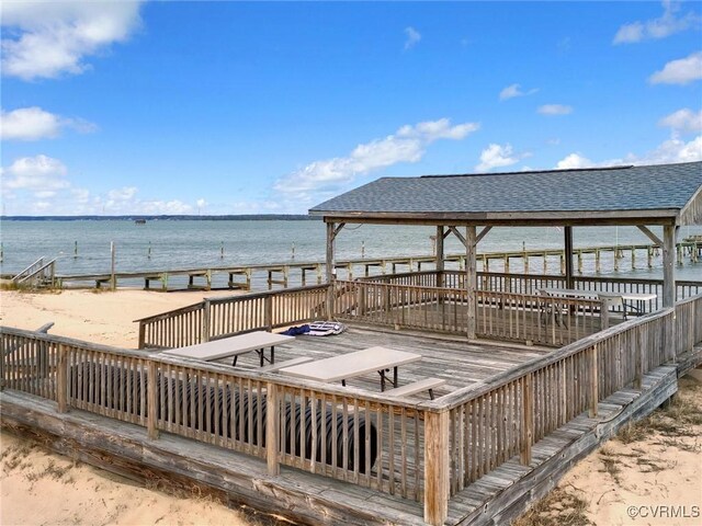 dock area featuring a water view and a view of the beach