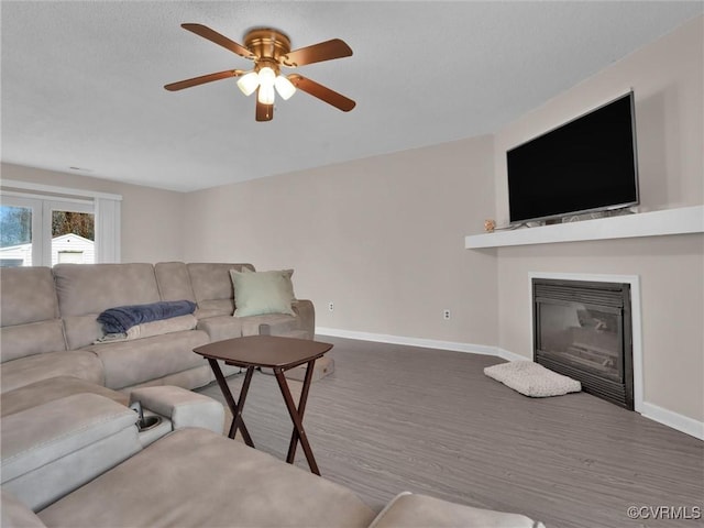 living room with ceiling fan and hardwood / wood-style floors