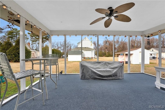 sunroom / solarium with ceiling fan and a healthy amount of sunlight