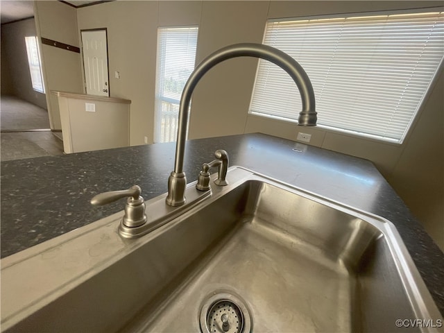 interior details with dark stone countertops and sink