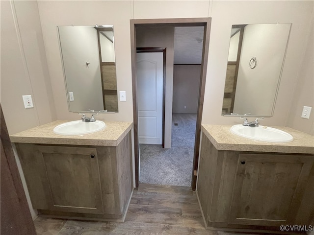 bathroom with vanity and hardwood / wood-style flooring