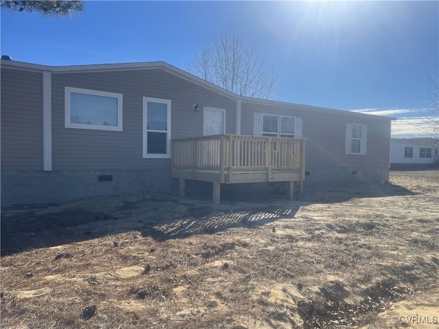 back of property featuring a wooden deck