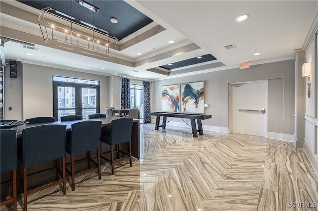 recreation room featuring a raised ceiling, crown molding, french doors, and light parquet floors