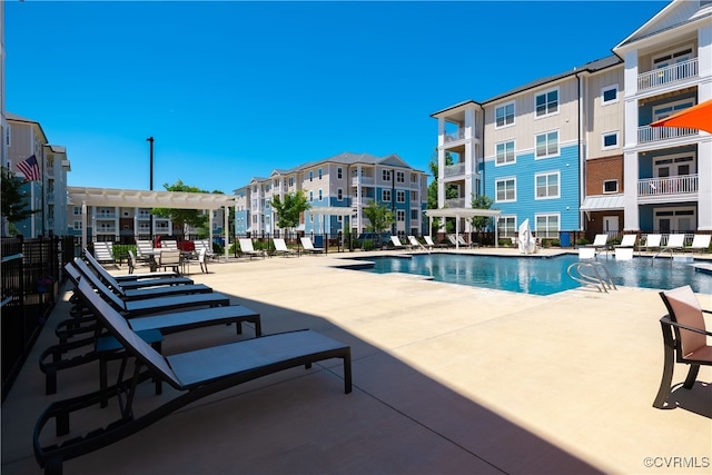 view of pool with a pergola and a patio