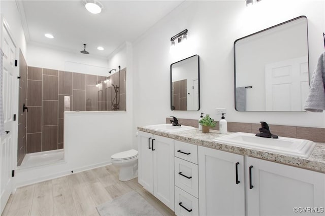 bathroom featuring crown molding, wood-type flooring, and walk in shower