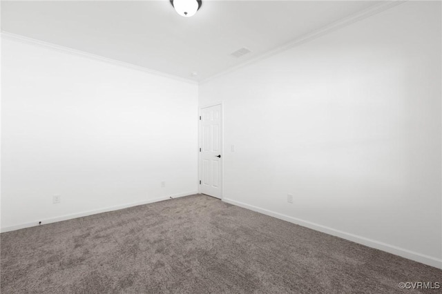 empty room featuring crown molding and carpet floors