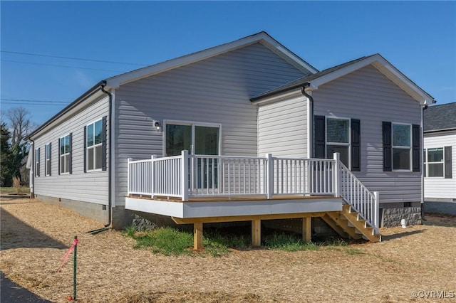 rear view of house with a wooden deck