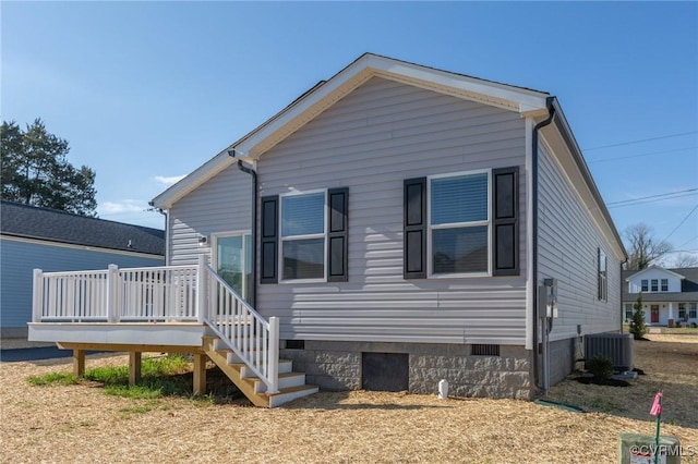 back of property featuring central AC and a wooden deck