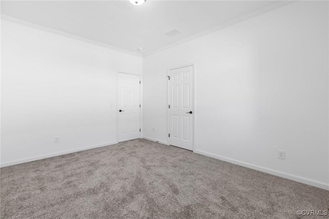 spare room featuring crown molding and carpet floors