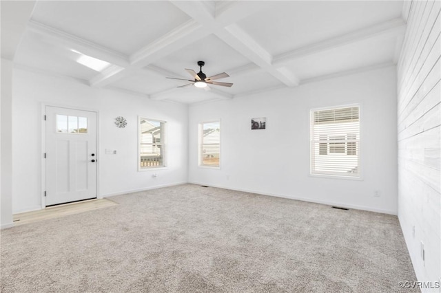 spare room with beamed ceiling, light carpet, and coffered ceiling