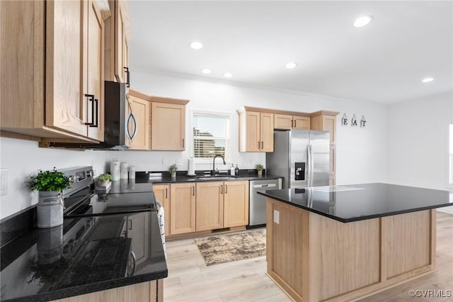 kitchen featuring light brown cabinets, a center island, sink, light hardwood / wood-style flooring, and appliances with stainless steel finishes