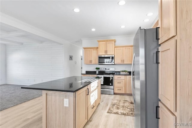 kitchen featuring appliances with stainless steel finishes, light brown cabinets, beamed ceiling, a center island, and light hardwood / wood-style floors