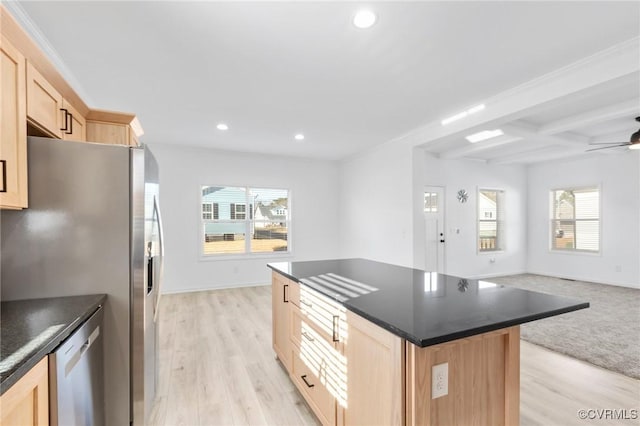 kitchen featuring light brown cabinetry, beamed ceiling, plenty of natural light, and light hardwood / wood-style flooring