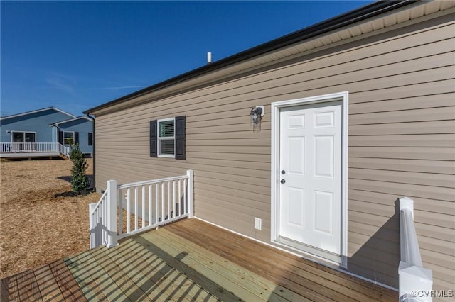 view of exterior entry featuring a deck