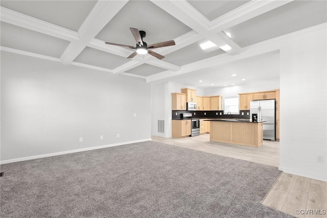 unfurnished living room featuring ceiling fan, crown molding, beamed ceiling, and coffered ceiling