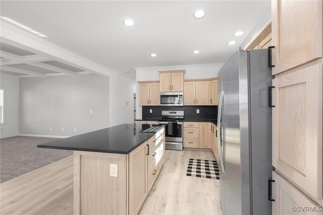 kitchen featuring a center island, light brown cabinets, beamed ceiling, decorative backsplash, and appliances with stainless steel finishes