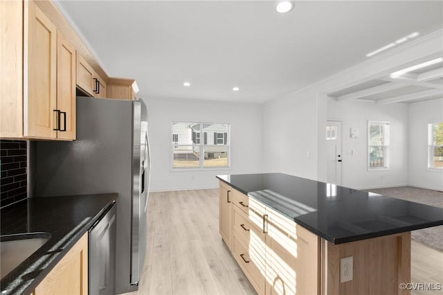 kitchen with tasteful backsplash, dishwasher, a center island, light brown cabinets, and light wood-type flooring