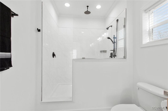 bathroom featuring toilet and tiled shower