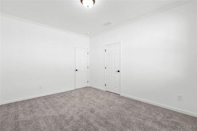 carpeted empty room featuring ornamental molding