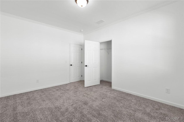 spare room with crown molding and carpet floors