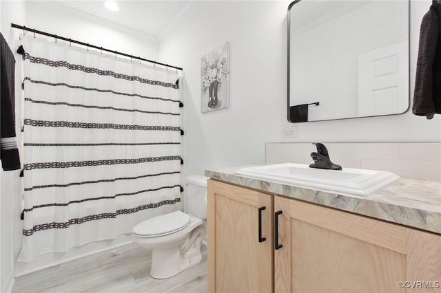 bathroom with hardwood / wood-style flooring, vanity, and toilet