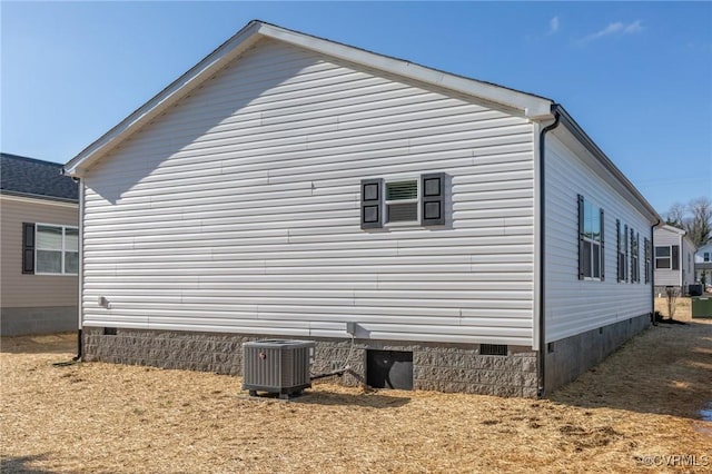 view of side of property with central air condition unit