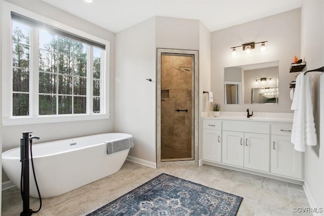 5080 Brandon Pines Way, Providence Forge, VA 23140 - full bathroom featuring a soaking tub, baseboards, vanity, and a stall shower