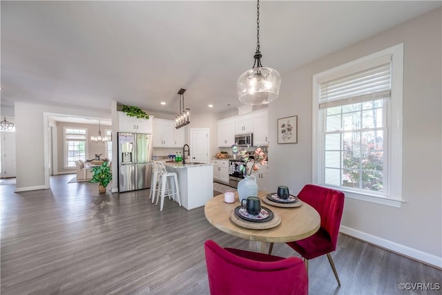 5080 Brandon Pines Way, Providence Forge, VA 23140 - dining area featuring recessed lighting, dark wood finished floors, an inviting chandelier, and baseboards