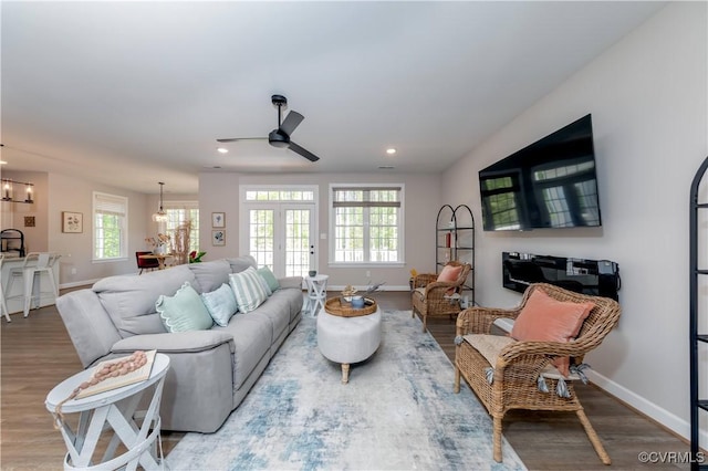 5080 Brandon Pines Way, Providence Forge, VA 23140 - living room with baseboards, wood finished floors, and ceiling fan with notable chandelier
