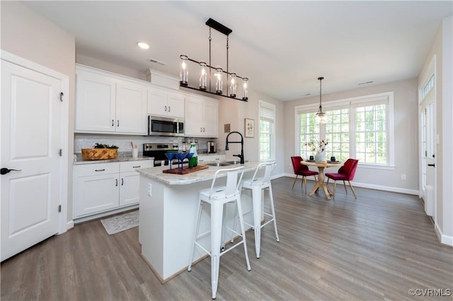 5080 Brandon Pines Way, Providence Forge, VA 23140 - kitchen featuring white cabinets, a sink, light wood-style floors, and appliances with stainless steel finishes